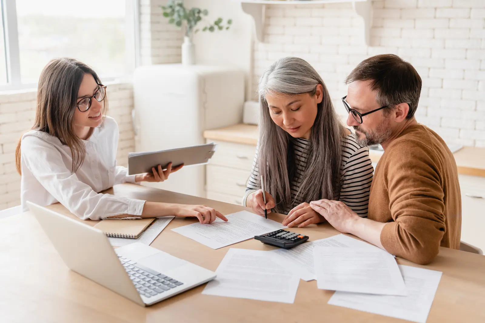 A couple sit at the table with a special needs trust lawyer making modifications to the trust